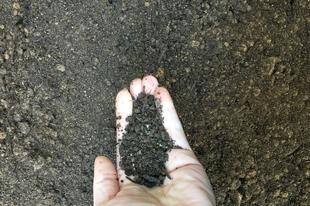 enriched topsoil product held by someones hand, keystone landscape supply